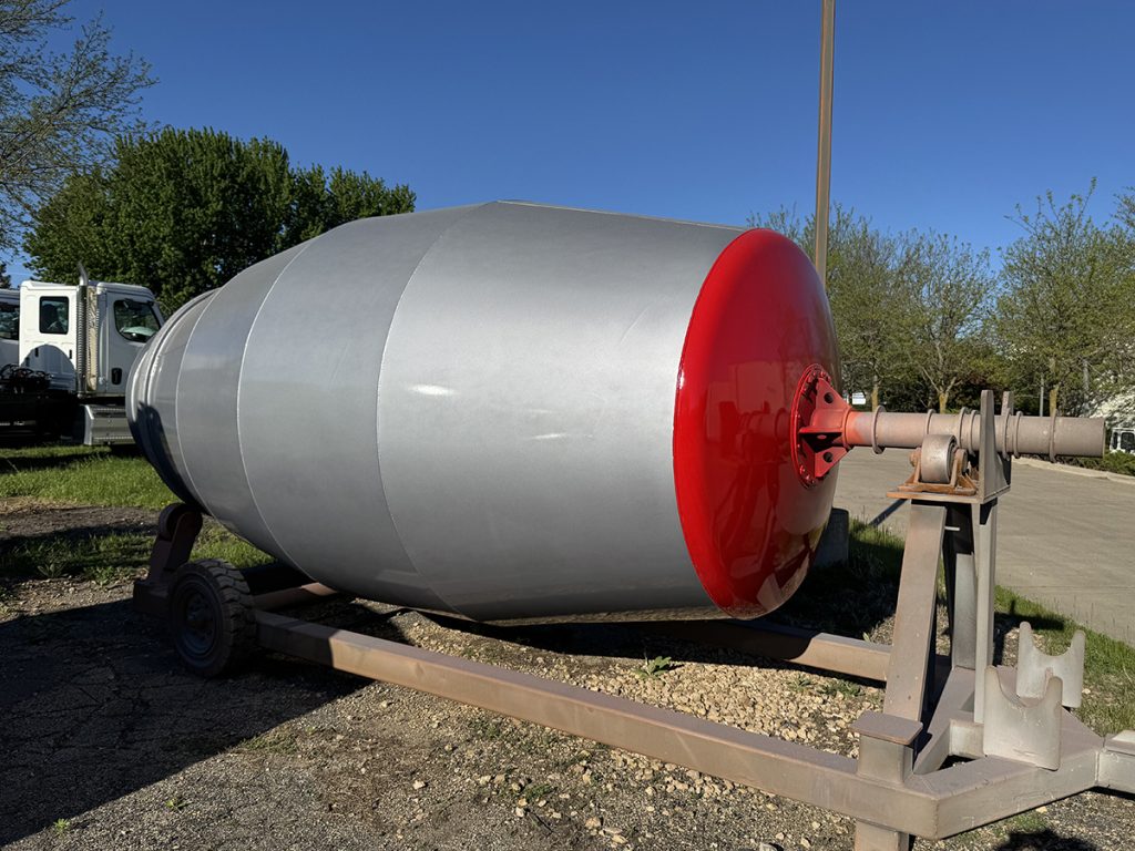 A red and gray aftermarket drum compatible with INTEGRAldx concrete ready mix trucks.