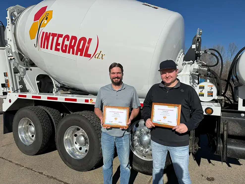 Two INTEGRALdx engineers with certificates for the Innovative Product Award, which INTEGRALdx one for its innovative RESULTS controls made for concrete ready-mix trucks.