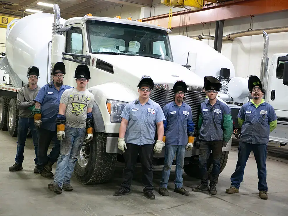 A group of SpecSys employees standing in front of a complete EASI REDI-Mix Truck.