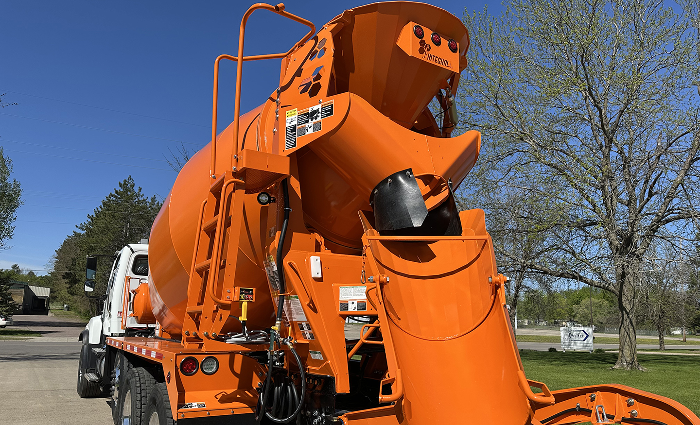 The rear of Carr Brothers' white and orange INTEGRALdx concrete redi-mix truck, with the discharge hopper located straight ahead.