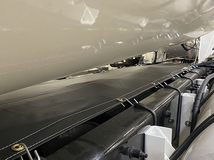 A chassis canvas cover on the bed of an INTEGRALdx concrete redi-mix truck, viewed at an angle from the left side.