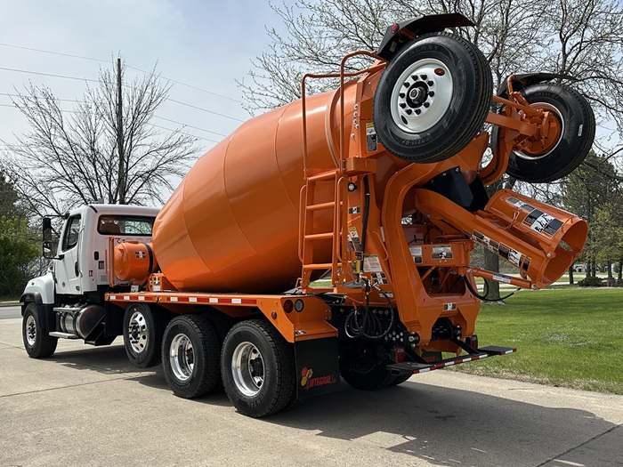 A concrete redi-mix truck with a white and orange color scheme built for Carr Bros.