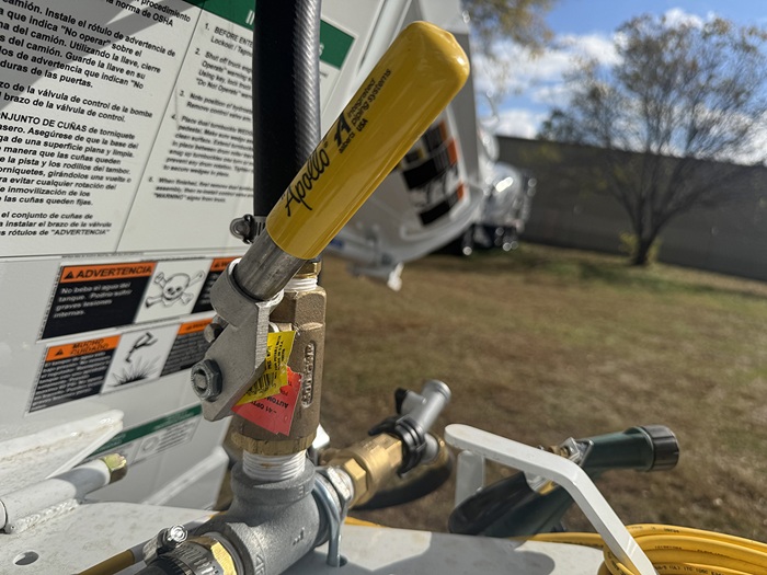 A yellow deadman valve located at the rear of an INTEGRALdx concrete redi-mix truck