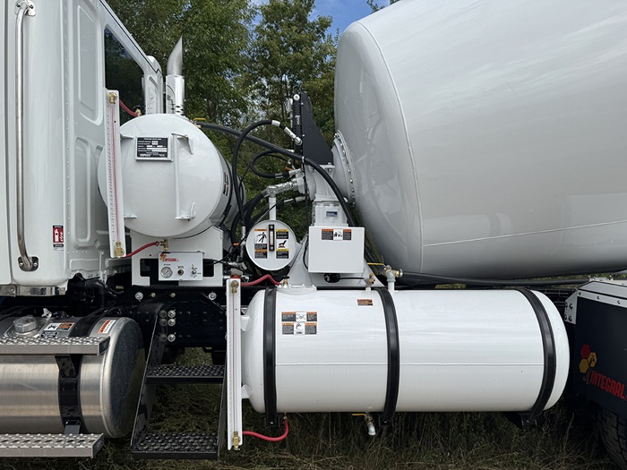 A dual water tank setup found between the cabin and drum of an INTEGRALdx concrete redi-mix truck.