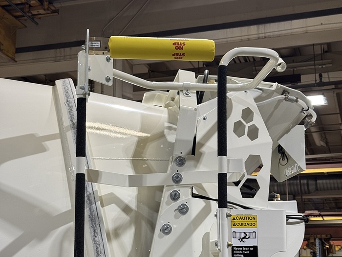 A side view of the man saver device atop the concrete redi-mix truck's ladder platform.