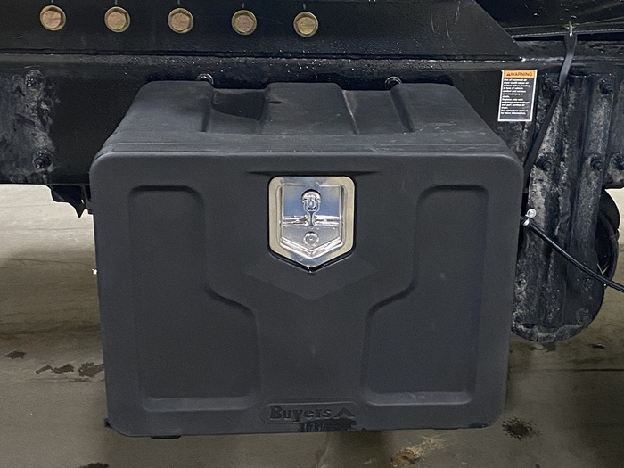 The front view of a 24 by 18 by 18 poly toolbox, featuring a shiny metallic latch