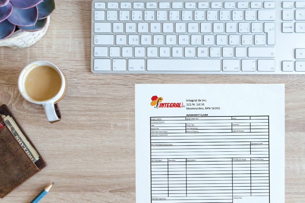 An image of a desk top with INTEGRALdx's warranty claim form on top of it.