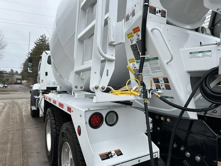 The rear left side of an EASI REDI-Mix Truck.