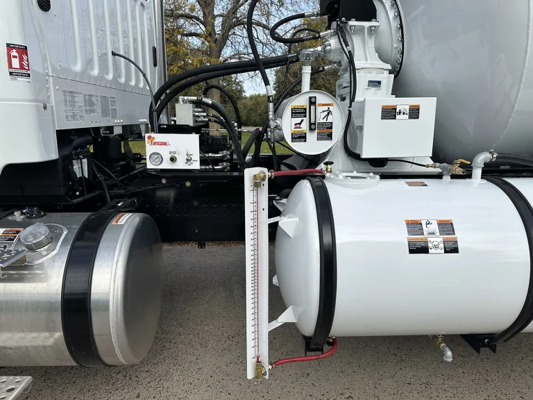 A close up of the left side of an EASI REDI Mix Truck, showing off the side-mounted water tank