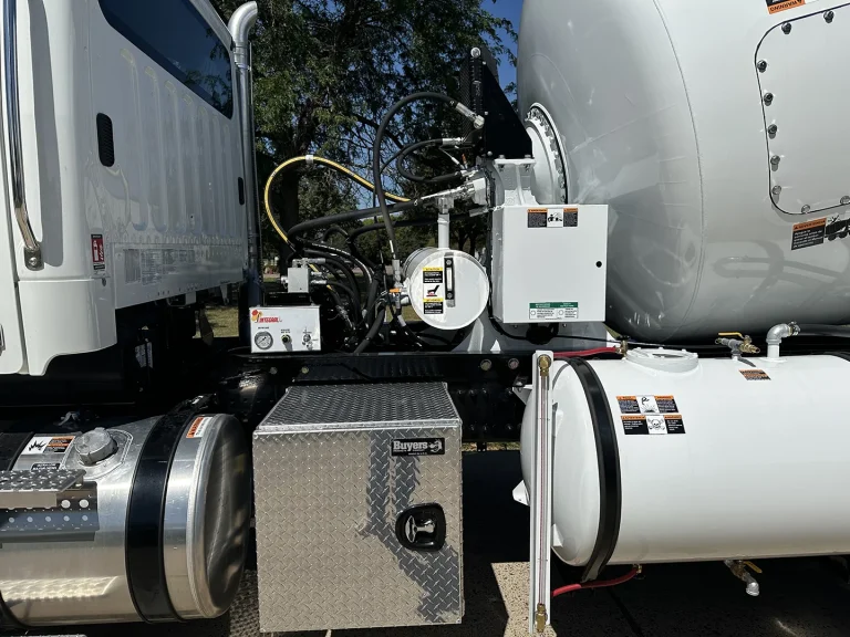 The gearbox, toolbox, and side-mounted water tank of an EASI REDI-Mix Truck